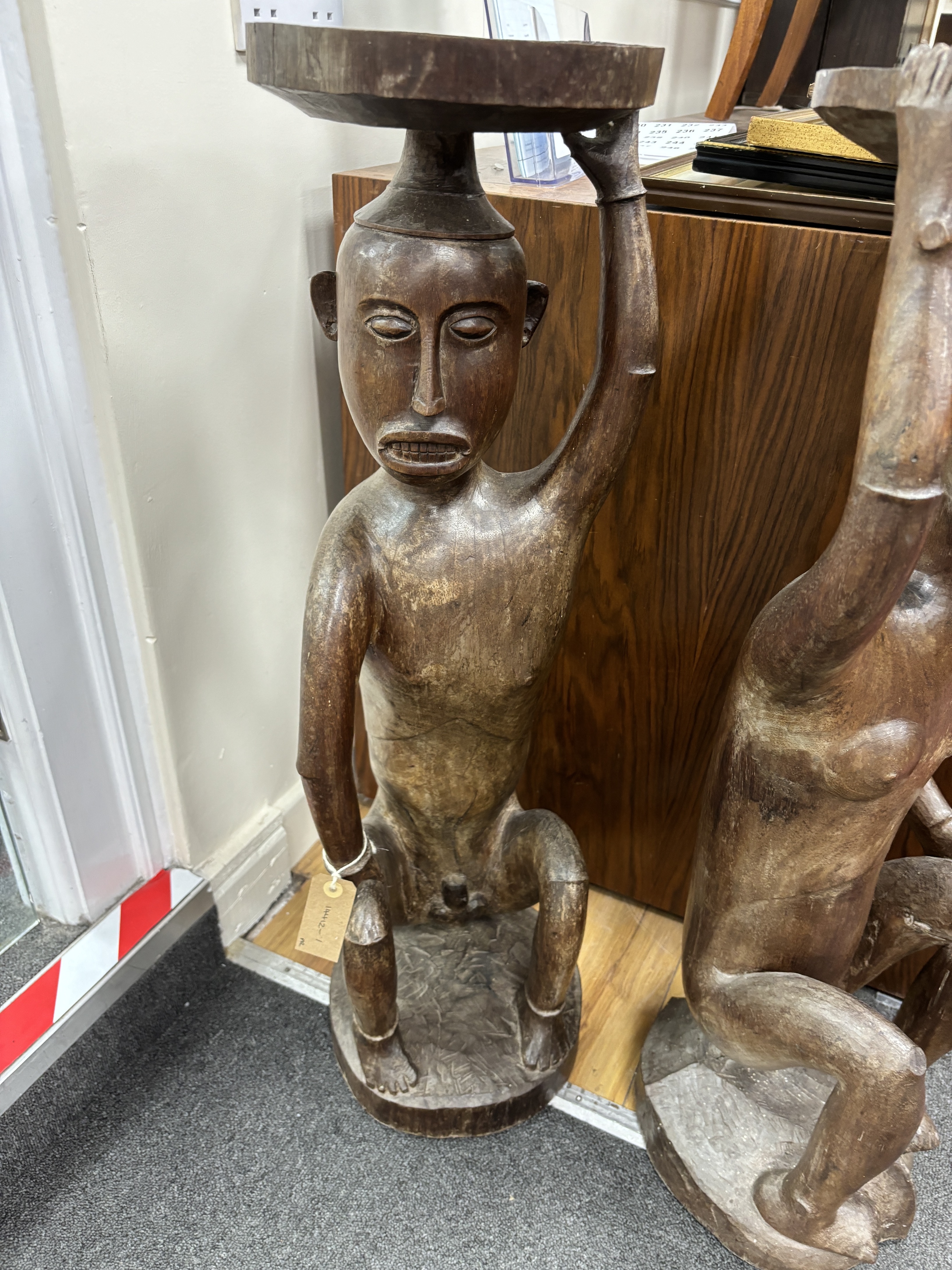 A pair of Sarawak carved hardwood figures. height 85cm
